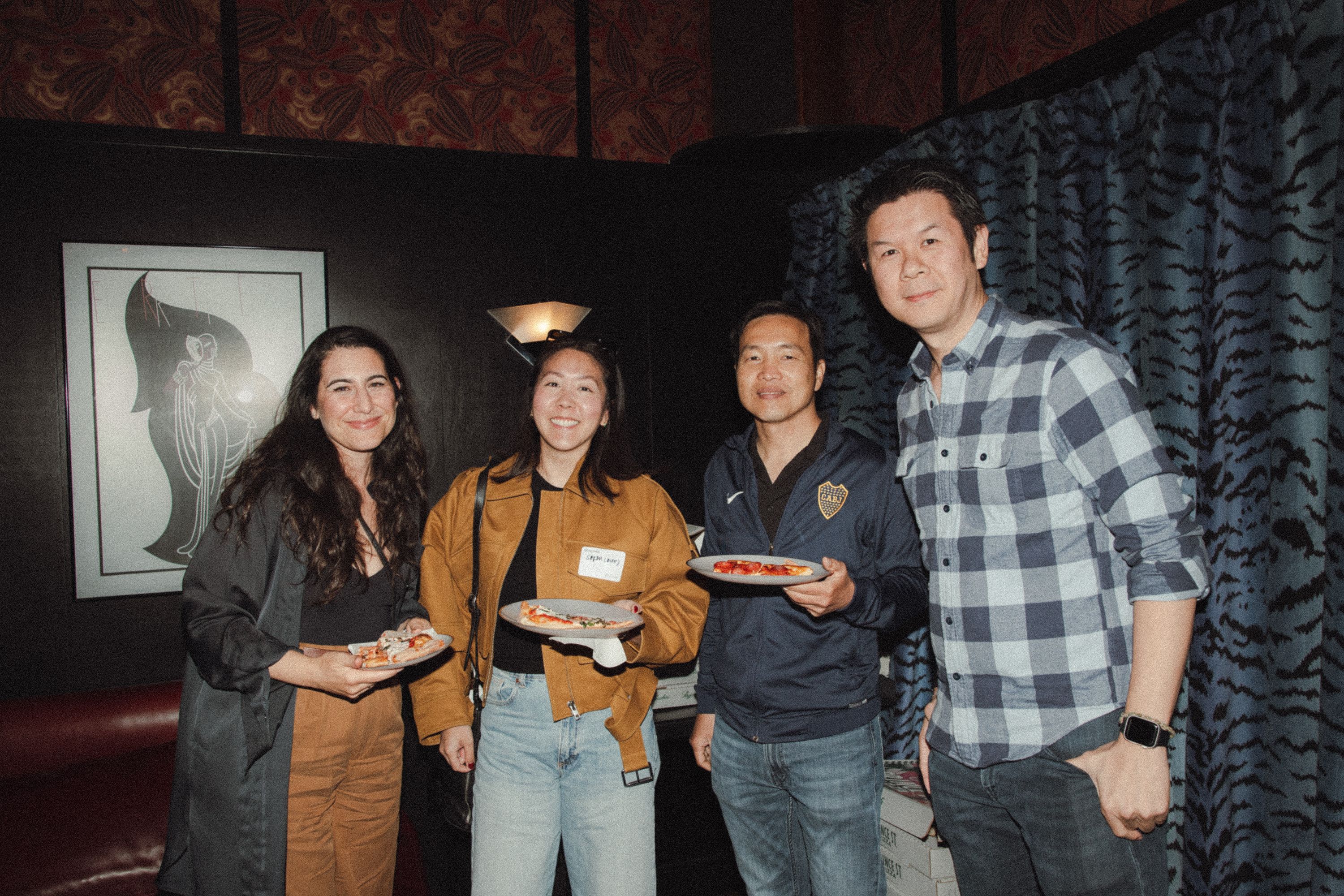 Guests holding pizza at the Mercury room