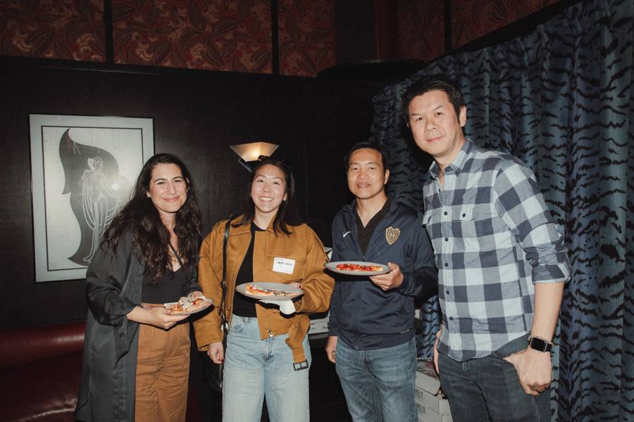 Guests holding pizza at the Mercury room